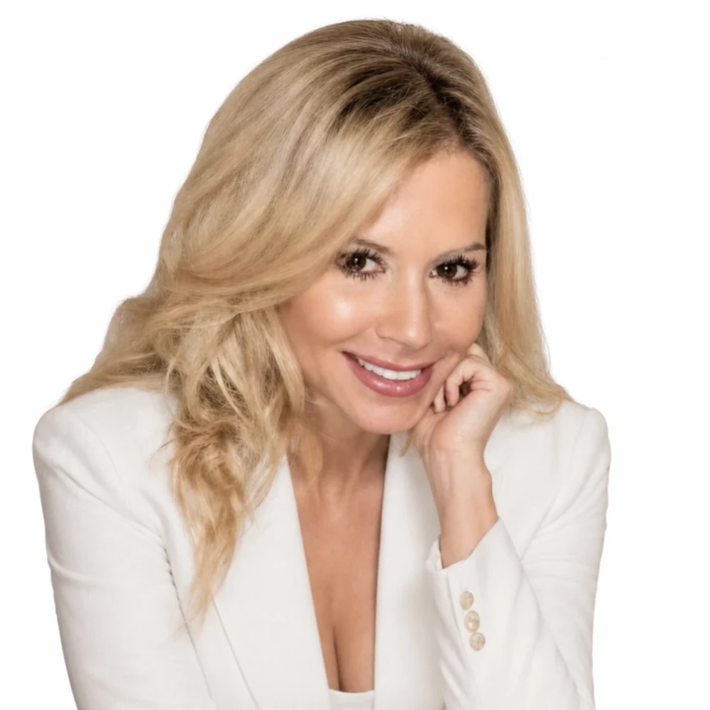 Karen Avila smiling in a white blazer